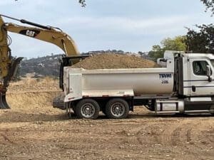 Excavating with dump truck