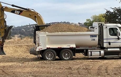 Excavating with dump truck